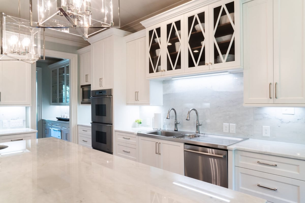 whole home remodel kitchen with glass front cabinets double sink and marble backsplash in charlotte nc