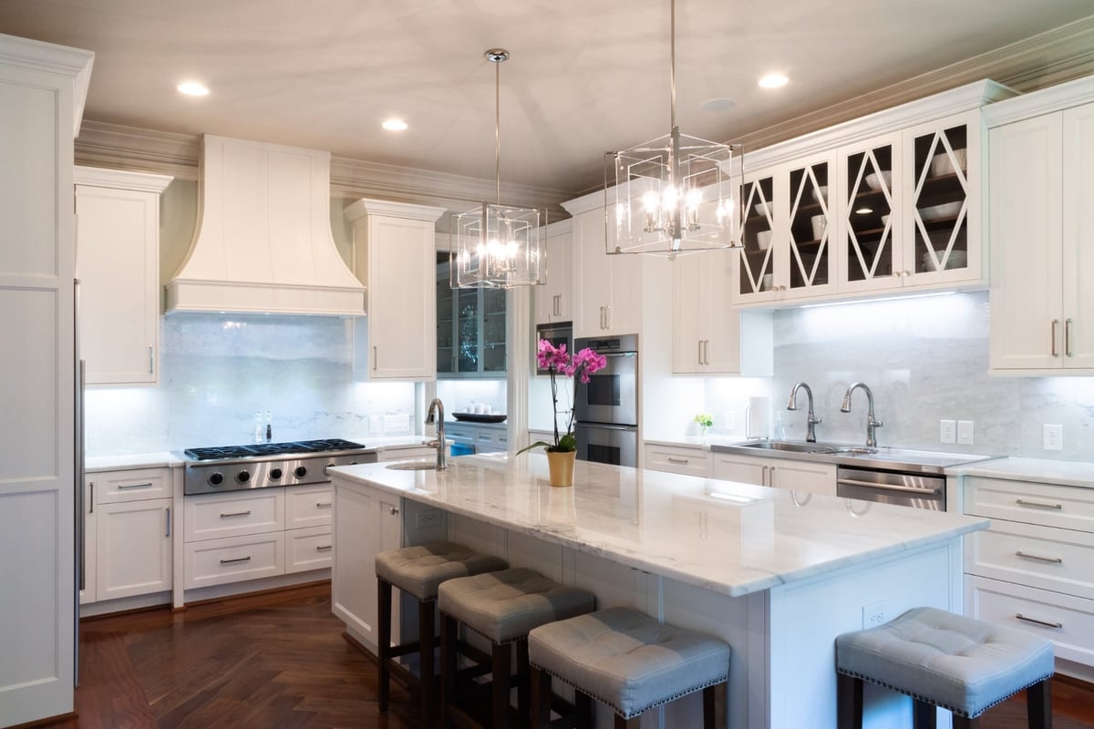 whole home remodel kitchen with large marble island white cabinetry and stainless appliances in charlotte nc