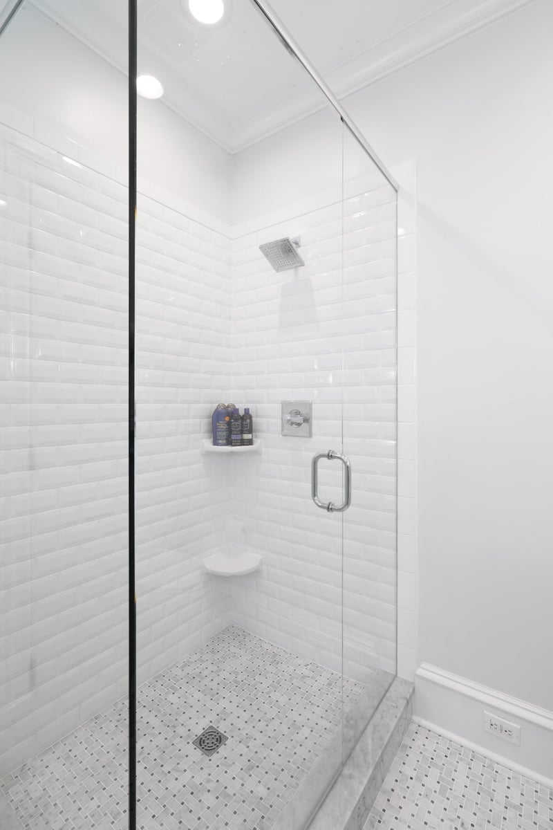 whole home remodel shower in charlotte nc with frameless glass white subway tile and mosaic floor