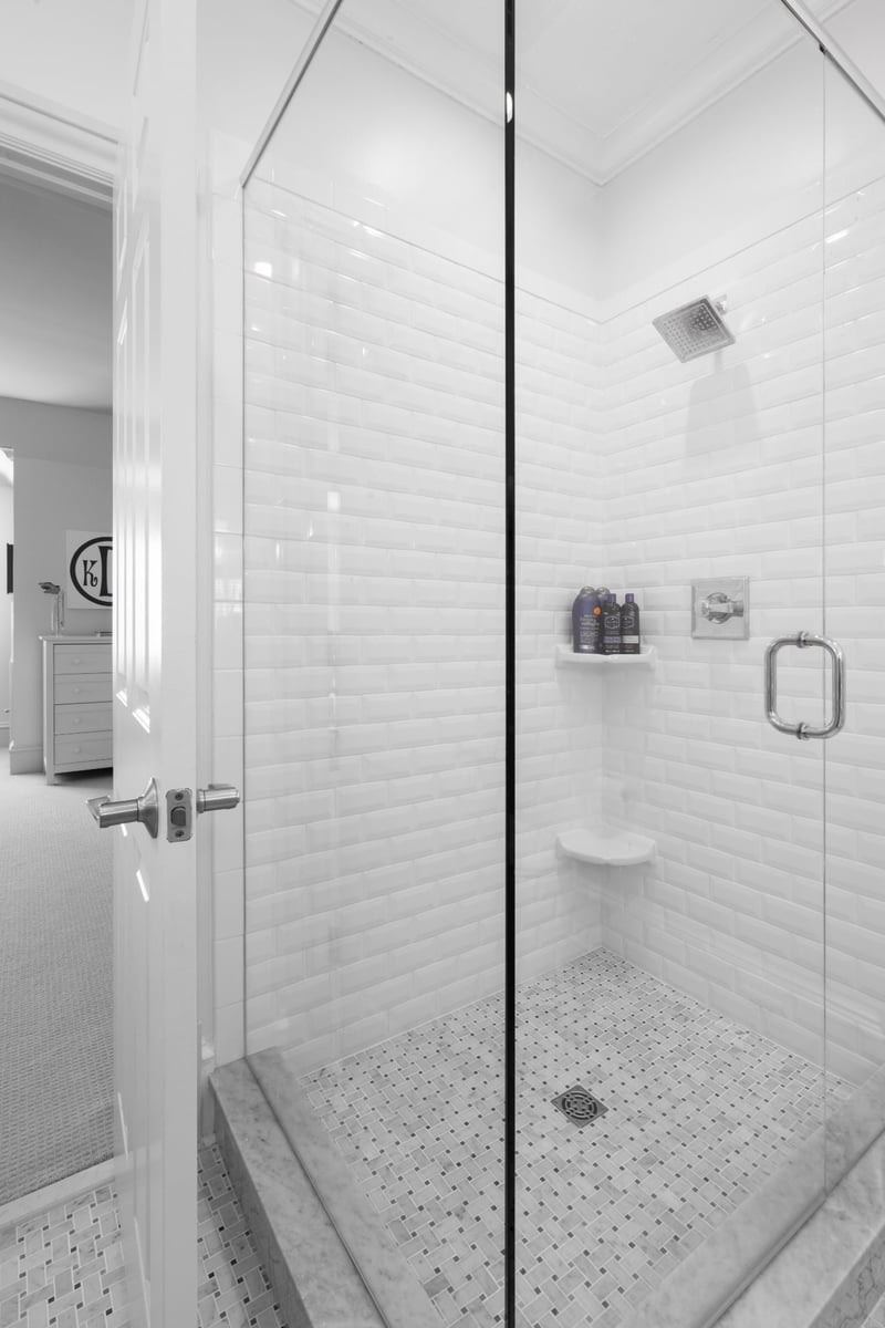 whole home remodel shower in charlotte nc with white subway tile mosaic floor and chrome fixtures