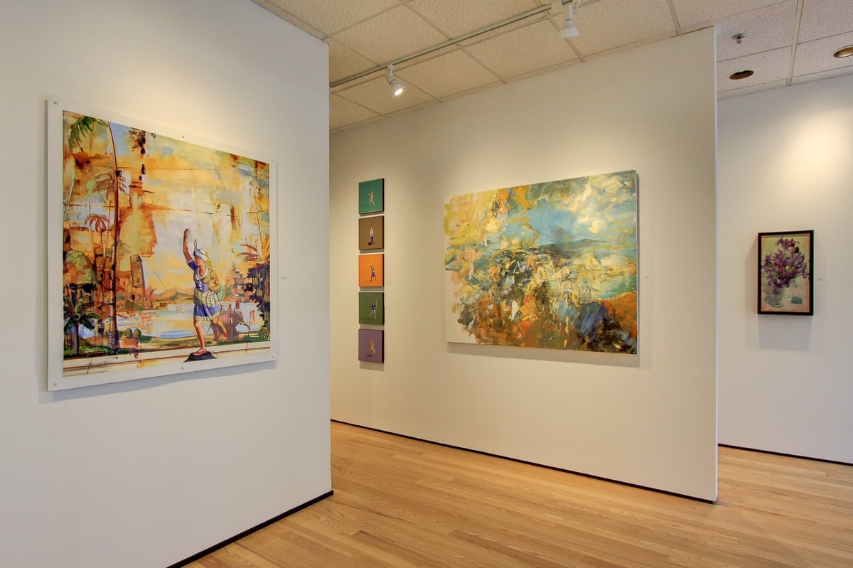 contemporary gallery interior with green landscape painting and mixed media art after a commercial remodel in charlotte nc