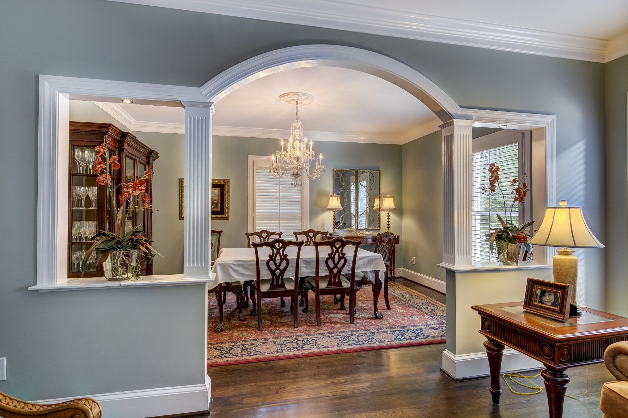 formal dining room with arched opening chandelier and wood furniture in charlotte nc whole home remodel