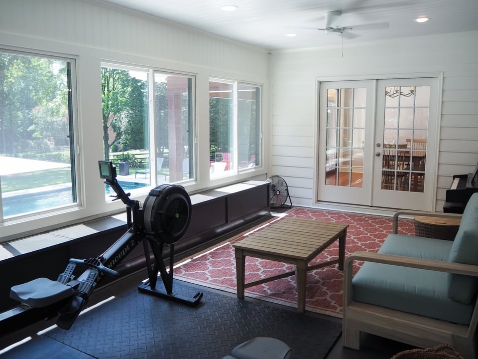 charlotte nc home project four season room lounge and gym with rowing machine pool views and large windows
