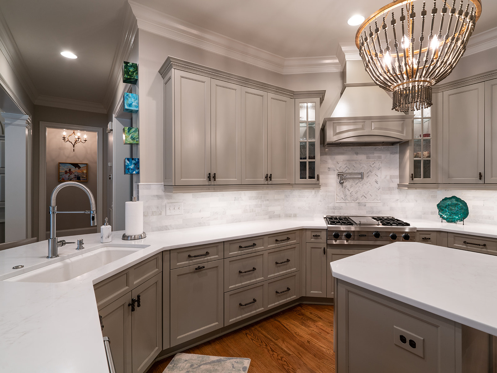 custom gray kitchen cabinets with marble backsplash and gas range in a Charlotte NC whole home remodel