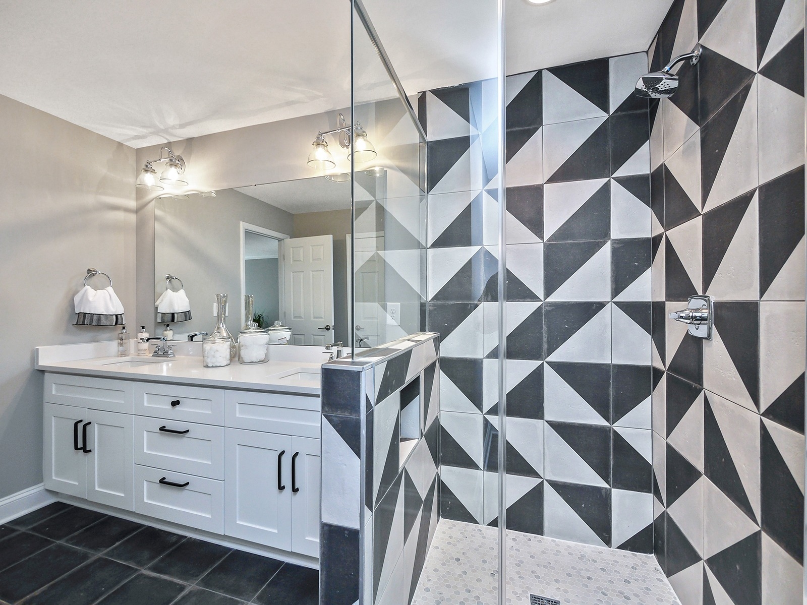 modern bathroom with black and white geometric tile shower