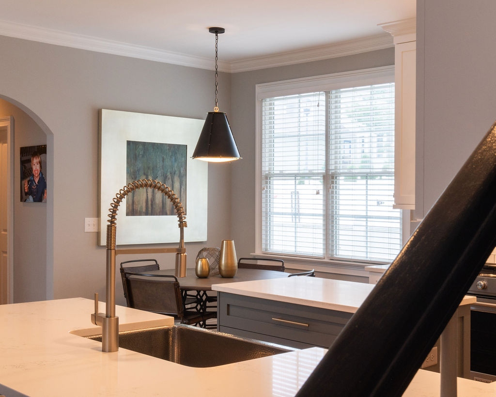 first floor remodel kitchen with farmhouse sink quartz peninsula and breakfast nook in fort mill sc