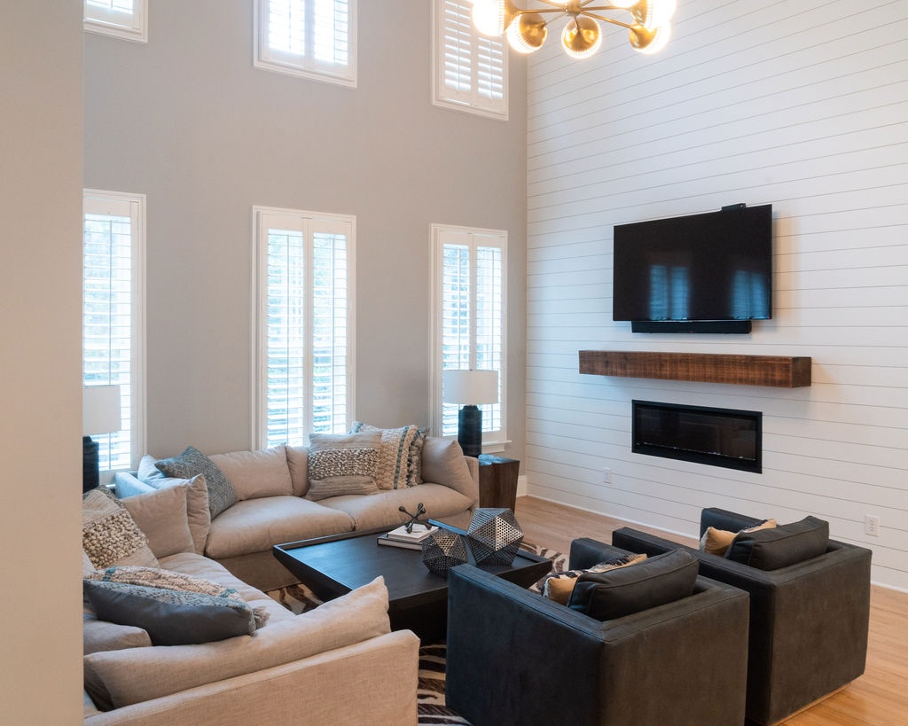 remodeled living room with tall windows shiplap fireplace and wood mantel in fort mill sc