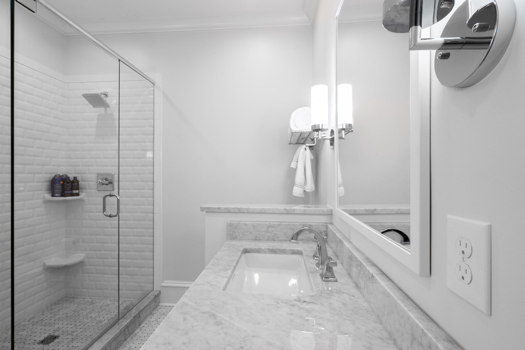 whole home remodel bathroom in charlotte nc with marble sink vanity glass shower and chrome fixtures