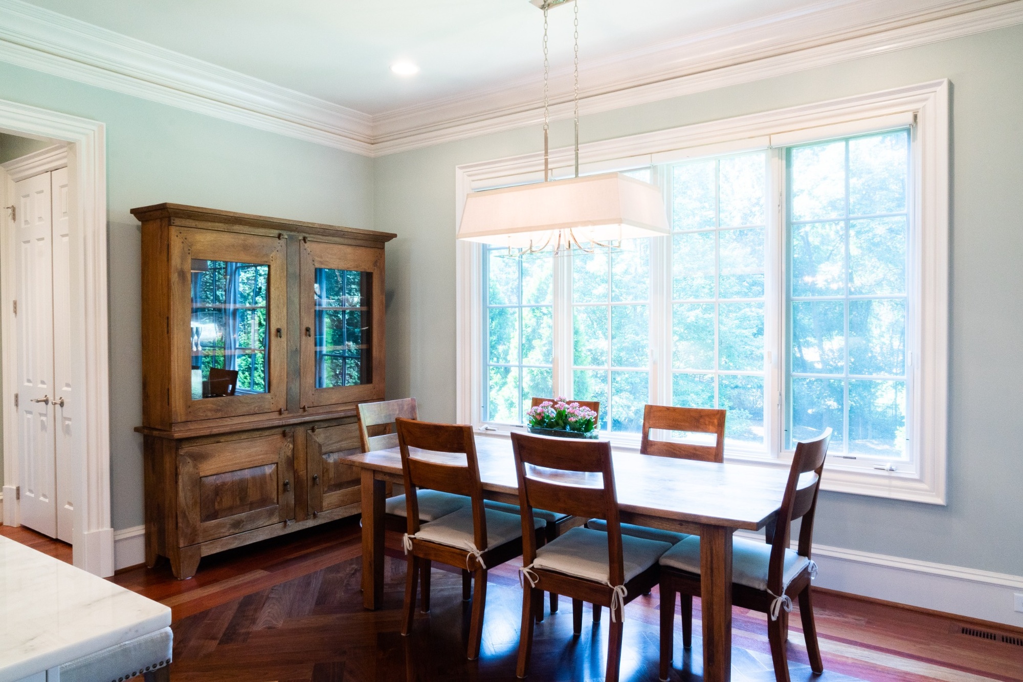 whole home remodel dining room with wood table hutch and large windows in charlotte nc