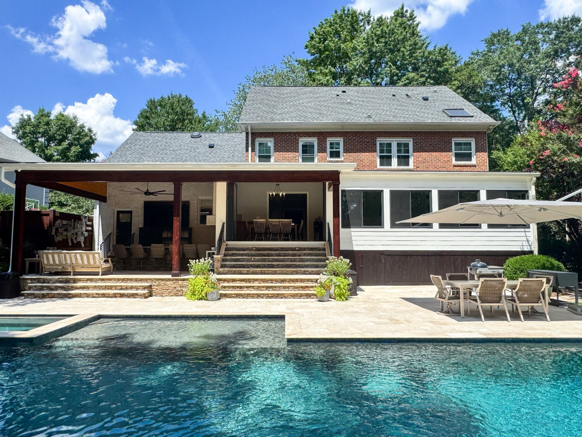 charlotte nc home project wide backyard pool with covered patio and brick home