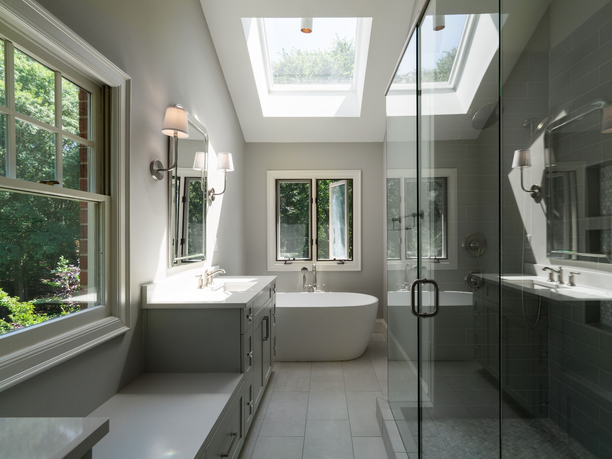 primary bathroom vanity with white countertop beveled mirror and skylight in charlotte nc home project