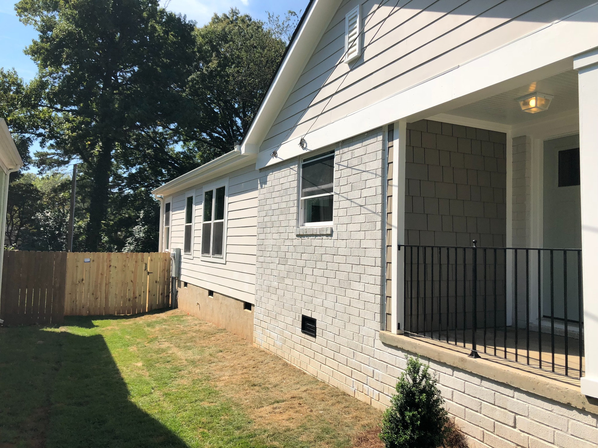 side exterior with covered porch and gray siding on charlotte nc addition