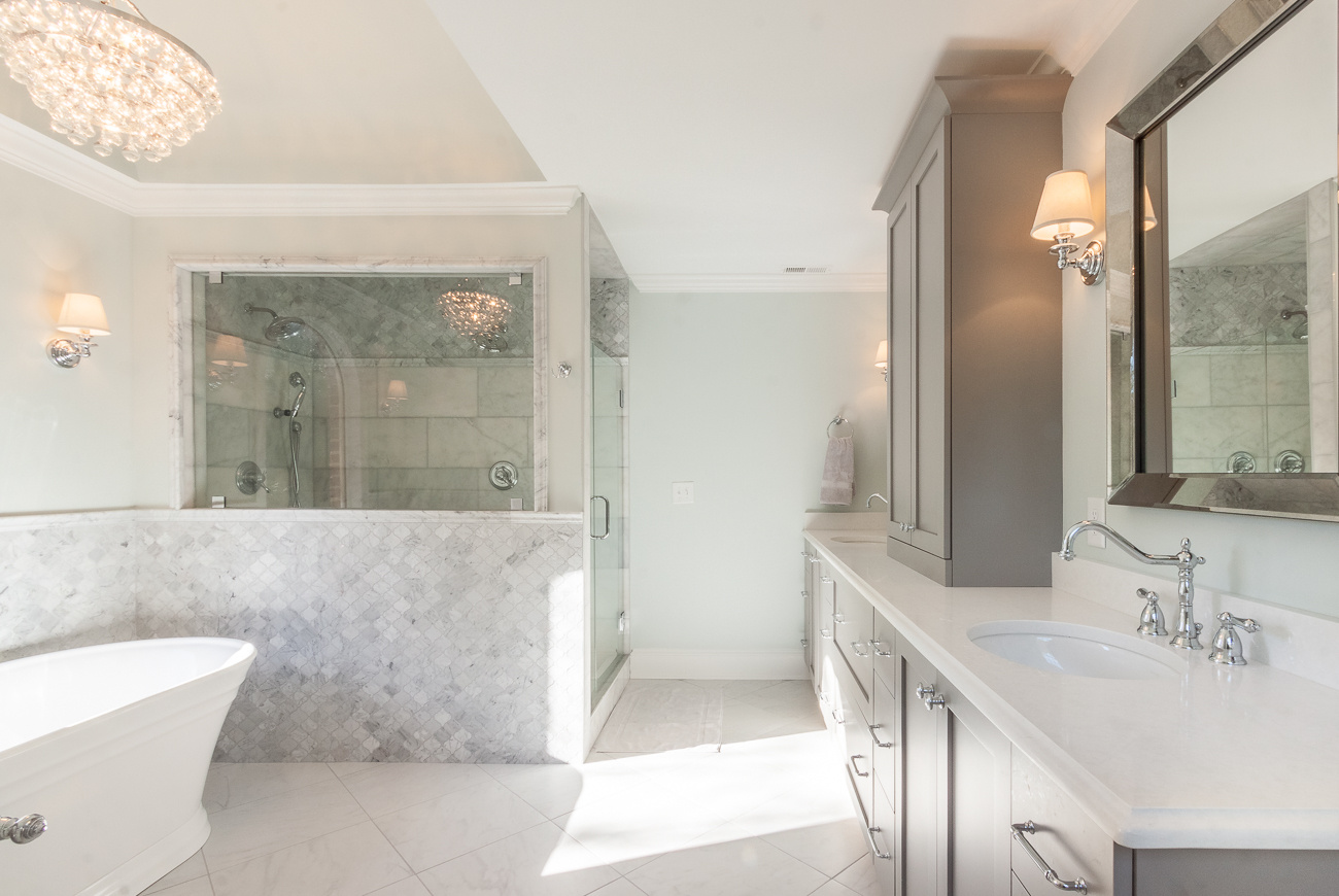 charlotte nc bathroom remodel with freestanding tub marble shower wall long gray vanity and framed mirror