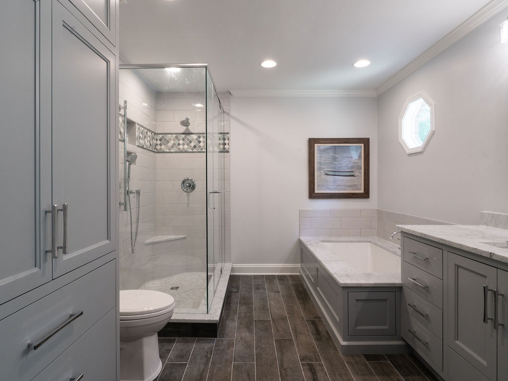 glass walk in shower soaking tub and gray cabinetry in charlotte nc bathroom remodel