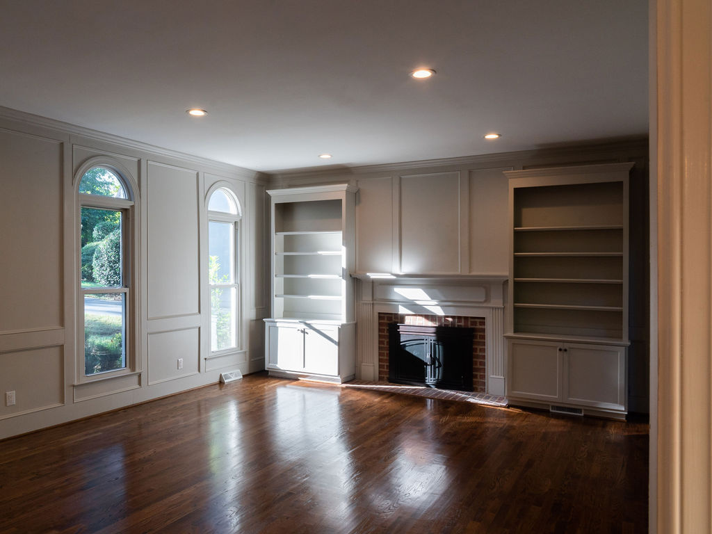 bright living room with arched windows fireplace built ins and hardwood floors in charlotte nc whole home remodel