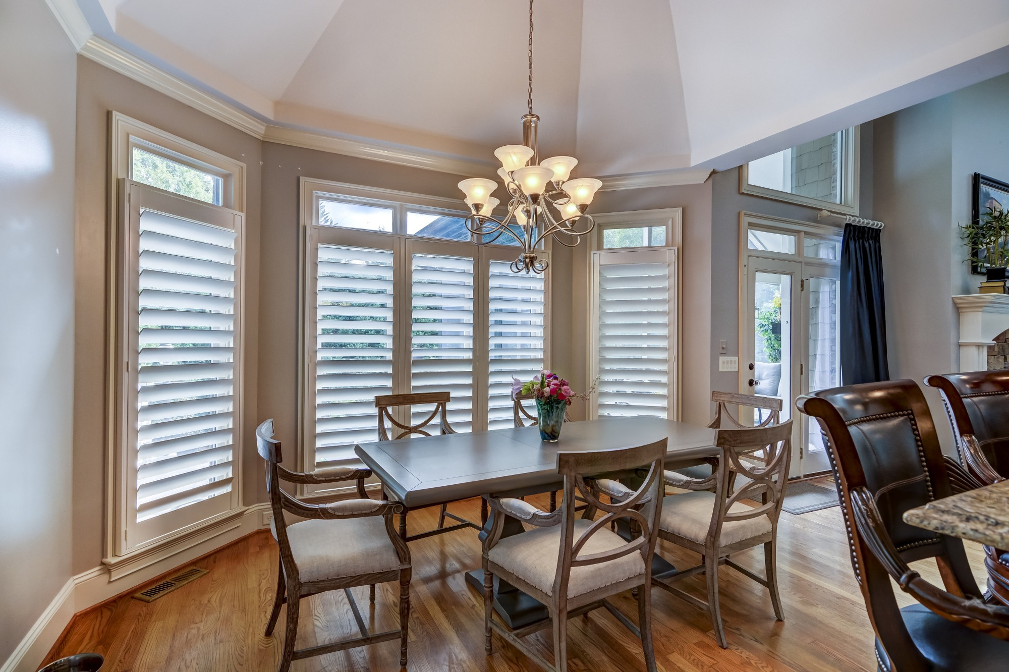 dining area with plantation shutters vaulted ceiling and wood table in a whole home remodel in charlotte nc