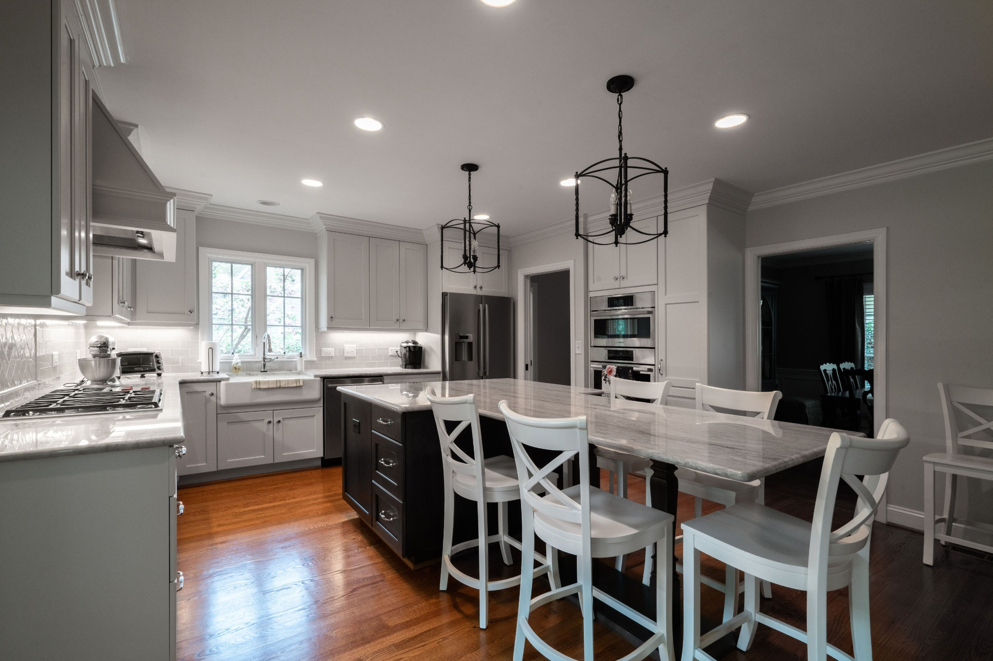 open kitchen with large marble island white seating and stainless appliances in charlotte nc whole home remodel