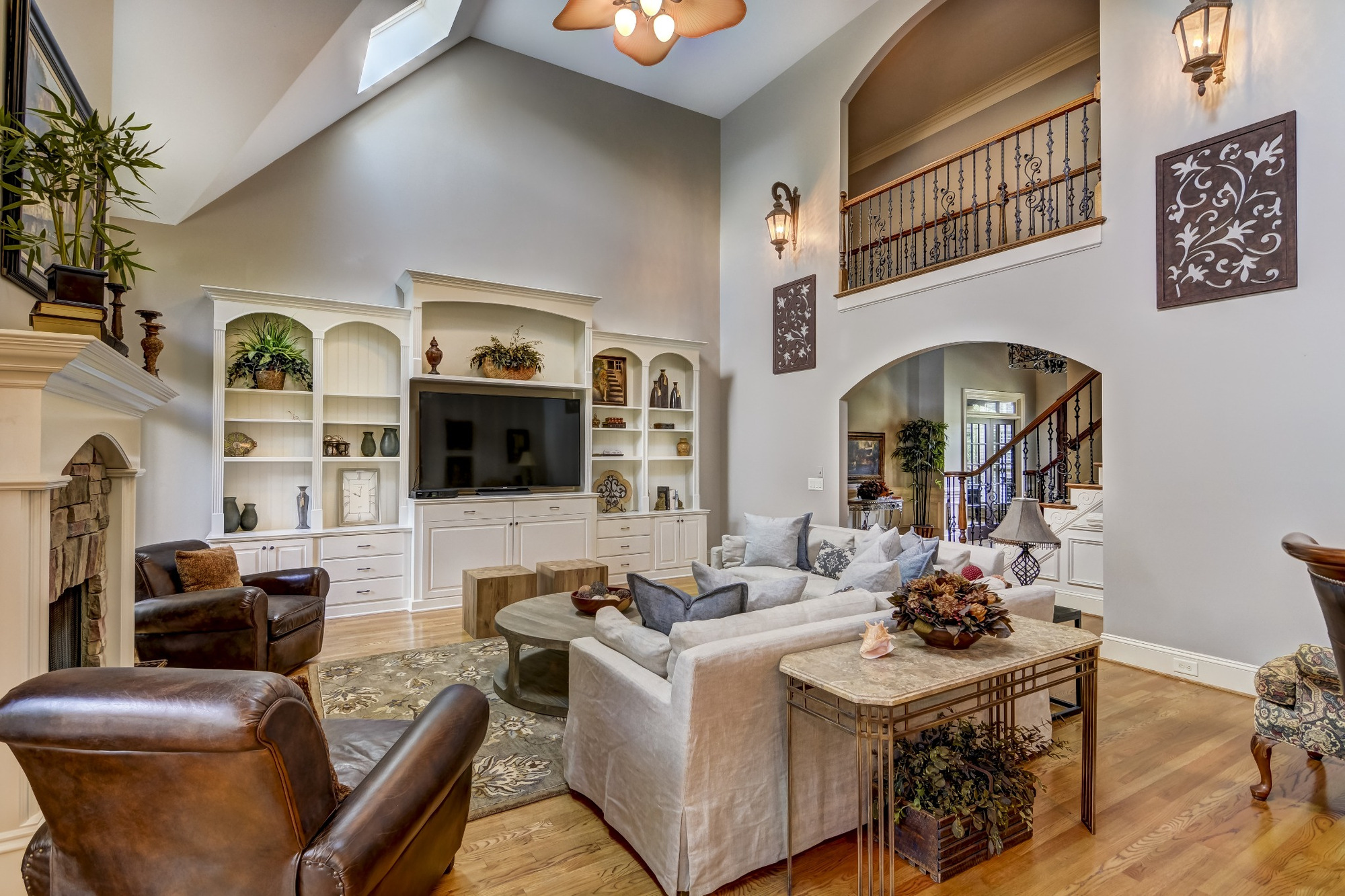 spacious living room with custom media center staircase and vaulted ceiling whole home remodel charlotte nc