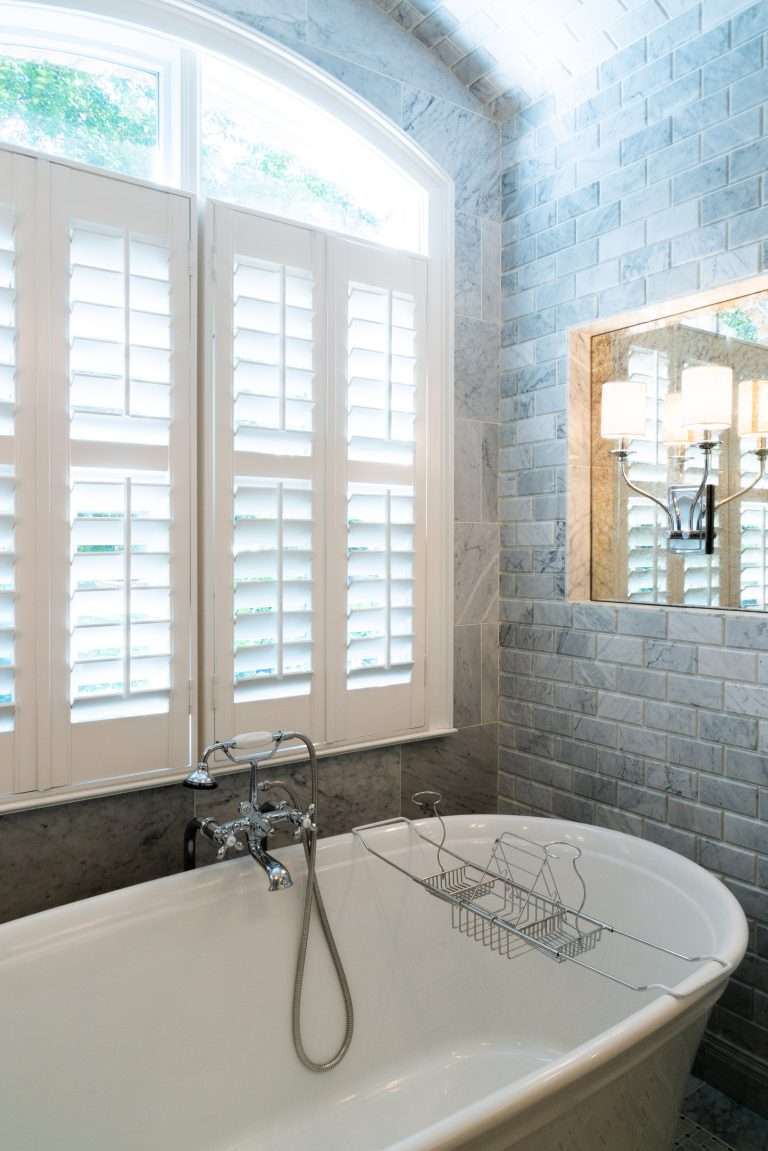 bathroom renovation showing bathtub, tile and window with shutters done by 7 Acre construction