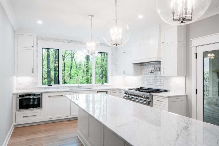 renovated kitchen with marble island and large windows done by 7 acre construction