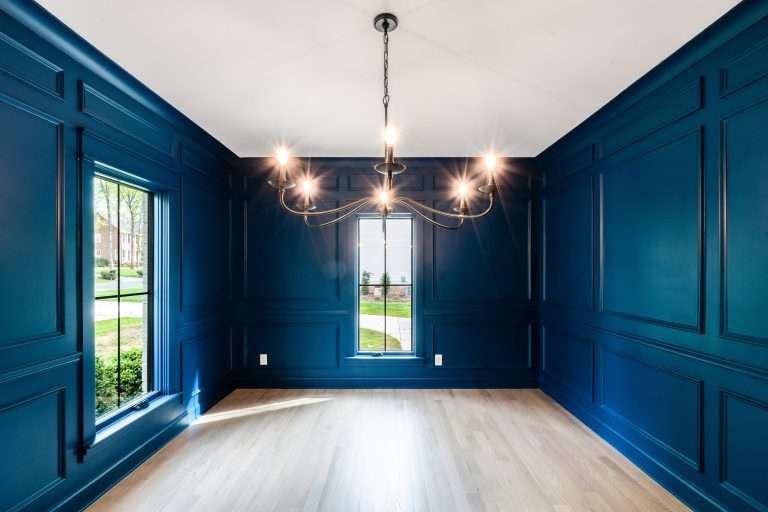 remodeled room with blue wood paneling and chandelier done by 7 acre construction